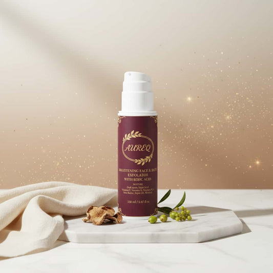 brightening Face & Body Exfoliator with kojic acid and vitamin C in pump bottle on marble display