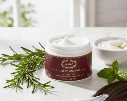 AUREQ Deep Cleanse Scalp Scrub, Rosemary & Mint product with fresh herbs on a white countertop.