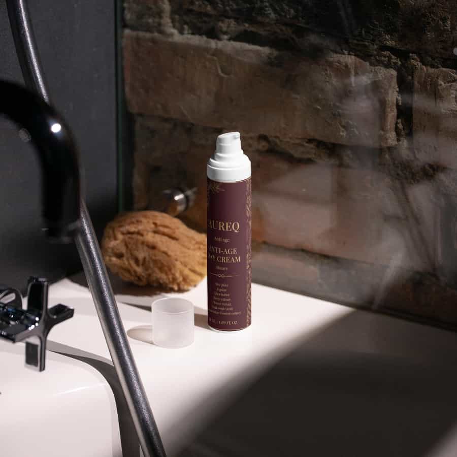 Hydrating day cream with hyaluronic acid from AUREQ on a bathroom countertop.